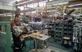77Factory.2.jpg - The assembly line was amazingly simple and short. It was just a horseshoe shaped line in which they merely pushed the cart along and started slapping things on the car.